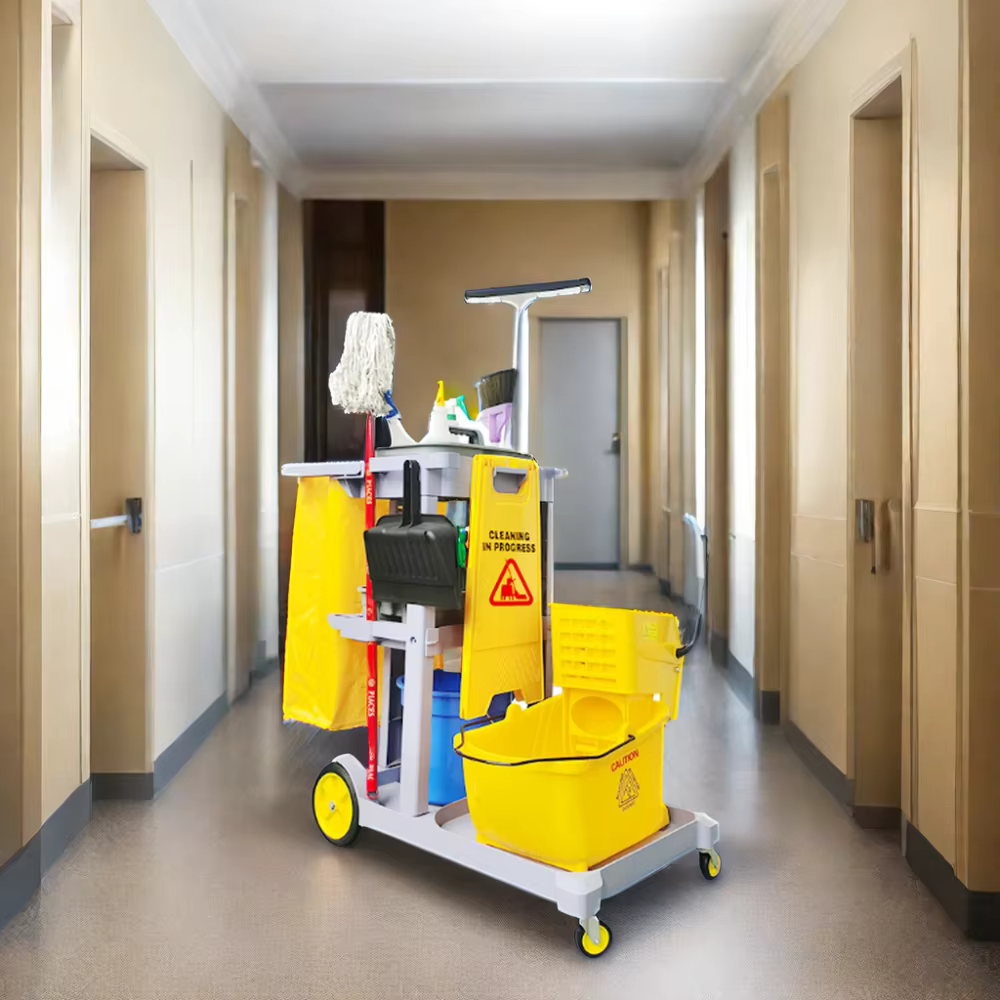 Janitorial services worker mopping a busy office hallway after employees leave for the day